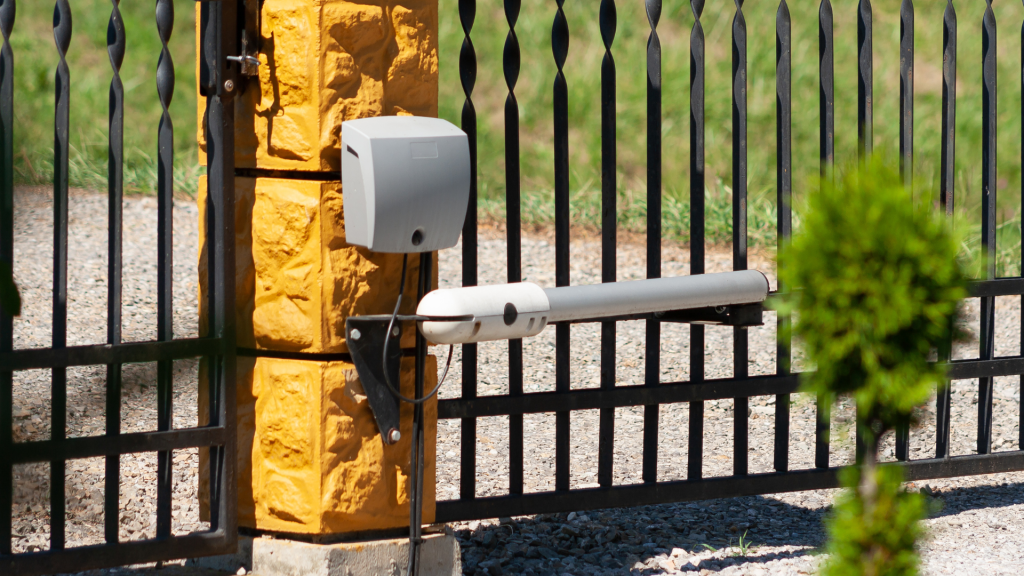 A gate with a yellow pole attached, providing access control and security.